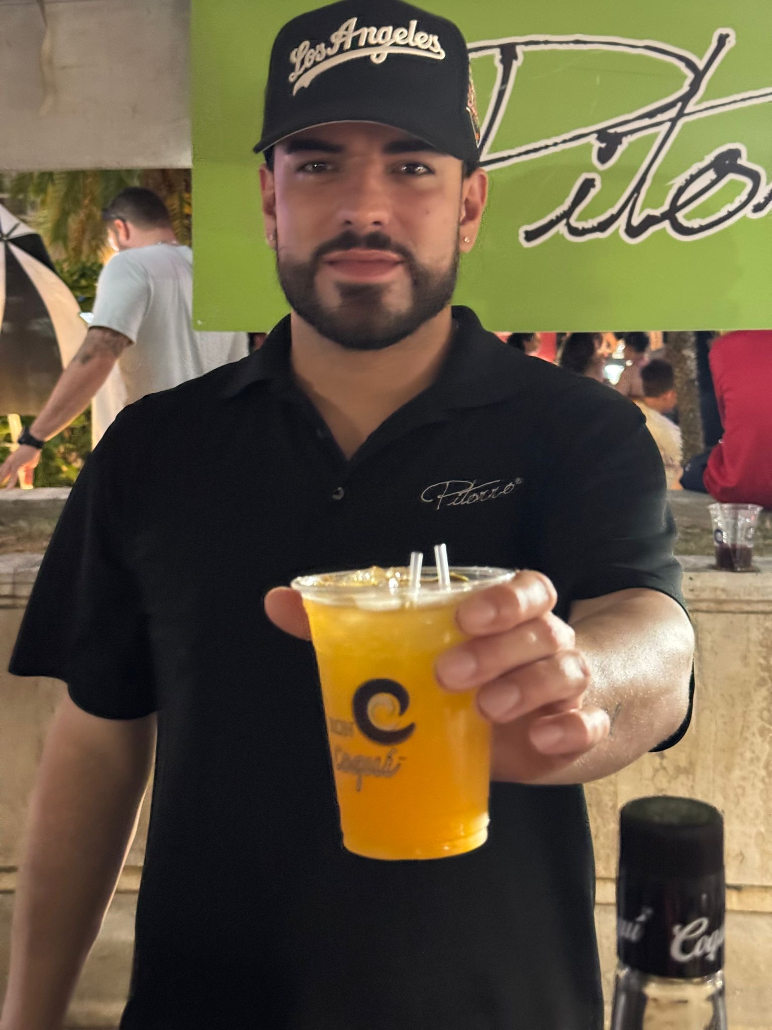 Cervezas del Oeste — bartender con bebida de mango en el festival